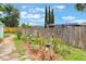 View of fenced yard featuring mulched garden area with plants and decorative elements at 109 Hunter Point Ct, Debary, FL 32713