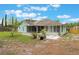 Wide backyard view featuring a patio, screened porch, and spacious lawn at 109 Hunter Point Ct, Debary, FL 32713