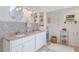 Bright bathroom featuring a double vanity, decorative mirrors, and tiled walls at 109 Hunter Point Ct, Debary, FL 32713