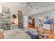 Inviting bedroom with hardwood floors, ceiling fan and a view into living area at 109 Hunter Point Ct, Debary, FL 32713