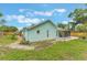 Back exterior showcasing a walkway and screened porch with a well-maintained lawn at 109 Hunter Point Ct, Debary, FL 32713