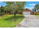 Traditional brick home featuring a two car garage and concrete driveway at 109 Hunter Point Ct, Debary, FL 32713