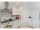 Well-lit kitchen featuring white cabinetry, updated appliances, and tiled backsplash at 109 Hunter Point Ct, Debary, FL 32713