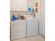 Functional laundry room with washer, dryer, and ample storage space at 109 Hunter Point Ct, Debary, FL 32713