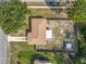 Aerial shot shows the home and backyard shed including a driveway and street view at 1276 Comerwood Dr, Deltona, FL 32738