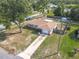 Aerial view of fenced-in house with a shed, large yard, and mature shade tree at 1276 Comerwood Dr, Deltona, FL 32738