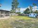 Large backyard featuring a well-maintained lawn, wooden fence, and storage shed, perfect for outdoor activities at 1276 Comerwood Dr, Deltona, FL 32738