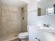 Bathroom featuring tiled shower with decorative border, and a modern white vanity at 1276 Comerwood Dr, Deltona, FL 32738