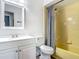 Bathroom featuring vanity, toilet, and bathtub with yellow tile surround and shower at 1276 Comerwood Dr, Deltona, FL 32738