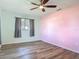 Bedroom with ceiling fan, hardwood floors, and large windows with natural light at 1276 Comerwood Dr, Deltona, FL 32738