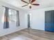 Bedroom featuring wood-look flooring, ceiling fan, and natural light from the window at 1276 Comerwood Dr, Deltona, FL 32738