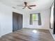 Bright bedroom showcasing wood-look floors, ceiling fan, and window providing natural light at 1276 Comerwood Dr, Deltona, FL 32738