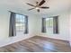 Bedroom with ceiling fan, hardwood floors, and large windows with natural light at 1276 Comerwood Dr, Deltona, FL 32738