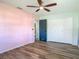 Bedroom with ceiling fan and hardwood floors, features a double closet at 1276 Comerwood Dr, Deltona, FL 32738