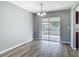 Dining area with sliding glass doors to the outdoor space, wood-look flooring, and elegant lighting fixtures at 1276 Comerwood Dr, Deltona, FL 32738