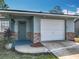 Close-up of the house with brick accents, front door and a one car garage at 1276 Comerwood Dr, Deltona, FL 32738