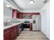 This spacious kitchen features wood cabinets, stainless appliances and light countertops at 1276 Comerwood Dr, Deltona, FL 32738