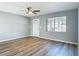 Bright and airy living room boasts wood-look flooring, a window view, and a white front door at 1276 Comerwood Dr, Deltona, FL 32738