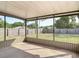 View of the home's screened porch featuring neutral paint and an unobstructed view of the backyard and surrounding greenery at 1276 Comerwood Dr, Deltona, FL 32738