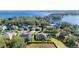 Breathtaking aerial view showcasing the home's proximity to a beautiful lake and lush greenery at 1301 Johns Cove Ln, Oakland, FL 34787