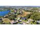 Serene aerial view of a neighborhood, highlighting lakeside properties and well-maintained landscaping at 1301 Johns Cove Ln, Oakland, FL 34787