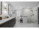 Elegant bathroom with dual vanities, a freestanding tub, and a walk-in shower at 1301 Johns Cove Ln, Oakland, FL 34787