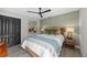 Well-decorated bedroom features stylish furnishings, neutral tones, ceiling fan, a window and ample closet space at 1301 Johns Cove Ln, Oakland, FL 34787