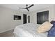 Relaxing bedroom with a mounted TV, ceiling fan, closet storage and neutral tones at 1301 Johns Cove Ln, Oakland, FL 34787