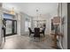 Well-lit dining room with wood-look floors and elegant light fixture situated near the entrance at 1301 Johns Cove Ln, Oakland, FL 34787
