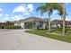View of home with a two car garage, well-manicured lawn, and meticulous landscaping at 1301 Johns Cove Ln, Oakland, FL 34787