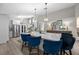 Modern kitchen showcasing a large island with seating and stylish pendant lighting at 1301 Johns Cove Ln, Oakland, FL 34787