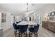 Spacious kitchen island with marble countertop, seating, and pendant lighting offers a place to gather at 1301 Johns Cove Ln, Oakland, FL 34787