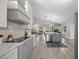 Bright, open kitchen with modern appliances, island with seating, and contemporary finishes at 1301 Johns Cove Ln, Oakland, FL 34787