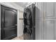 Convenient laundry room featuring stacked washer and dryer, and built-in gray storage cabinets at 1301 Johns Cove Ln, Oakland, FL 34787
