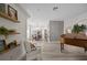 Living room featuring console table with botanicals, wood-look floors, and view into dining room at 1301 Johns Cove Ln, Oakland, FL 34787