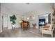 Bright living room boasts wood-look floors, grand piano and views of the bedroom at 1301 Johns Cove Ln, Oakland, FL 34787