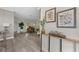 Bright living room showcasing wood-look floors, console table with botanicals and views of the grand piano at 1301 Johns Cove Ln, Oakland, FL 34787