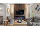 Elegant living room featuring a fireplace, modern lighting, comfortable seating, and a large screen television at 1301 Johns Cove Ln, Oakland, FL 34787