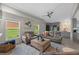Spacious living room with a custom bar area, comfortable seating, and large windows offering plenty of natural light at 1301 Johns Cove Ln, Oakland, FL 34787