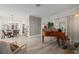 Spacious living room featuring a grand piano, stylish dining area, and wood-look flooring at 1301 Johns Cove Ln, Oakland, FL 34787