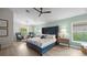 Bright main bedroom boasts a seating area and a plush bed with a high headboard at 1301 Johns Cove Ln, Oakland, FL 34787