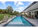 Outdoor covered pool with pavers, lounge chairs, and outdoor dining at 1301 Johns Cove Ln, Oakland, FL 34787