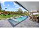 Outdoor covered pool with pavers, lounge chairs, and outdoor dining at 1301 Johns Cove Ln, Oakland, FL 34787