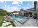 Outdoor covered pool with pavers, lounge chairs, and outdoor dining at 1301 Johns Cove Ln, Oakland, FL 34787