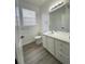 Bright bathroom with a vanity and a framed mirror at 13512 Turtle Marsh Loop # 729, Orlando, FL 32837