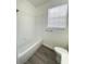 Clean bathroom with a shower/tub combo and gray wood-look floors at 13512 Turtle Marsh Loop # 729, Orlando, FL 32837
