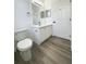 Bright bathroom featuring a modern vanity, mirror, and gray wood-look flooring at 13512 Turtle Marsh Loop # 729, Orlando, FL 32837