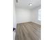 Empty bedroom with light gray wood-look floors, neutral paint, and a window at 13512 Turtle Marsh Loop # 729, Orlando, FL 32837