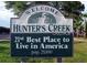Welcome to Hunter's Creek sign displayed proudly with a lush tree backdrop at 13512 Turtle Marsh Loop # 729, Orlando, FL 32837