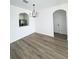 A modern dining room with vinyl plank floors and an adjacent view into the kitchen at 13512 Turtle Marsh Loop # 729, Orlando, FL 32837